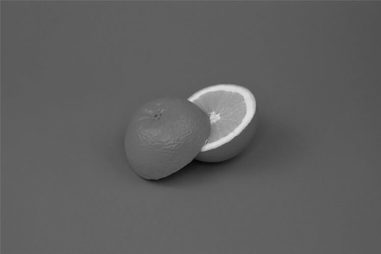 The same orange photo converted to shades of gray